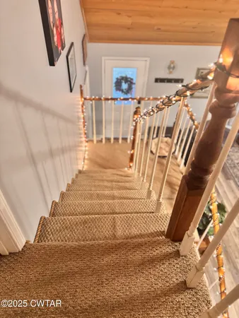 a view of a bedroom with wooden floor and windows