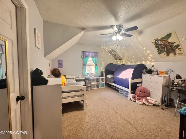 a bedroom with furniture and a chandelier