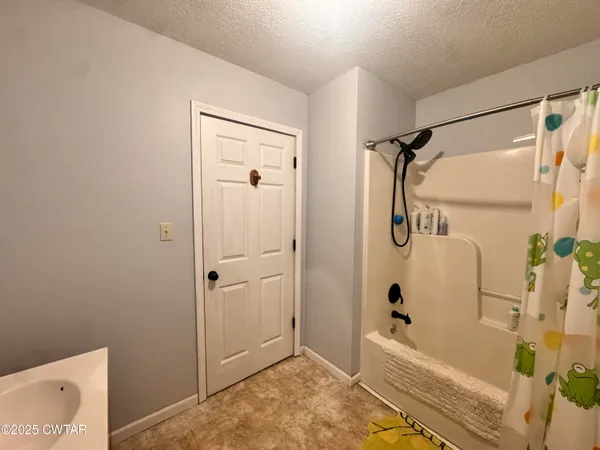 a bathroom with a tub and shower