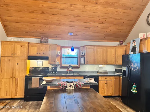 a kitchen with granite countertop a refrigerator and a stove