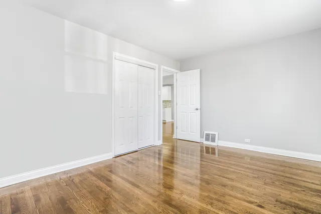 an empty room with wooden floor