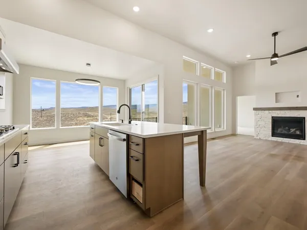 a kitchen with sink stove and refrigerator