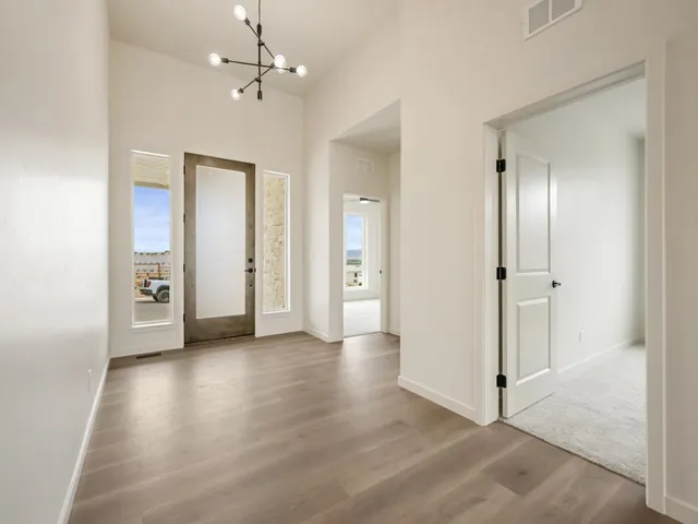 wooden floor in an empty room with a bathroom