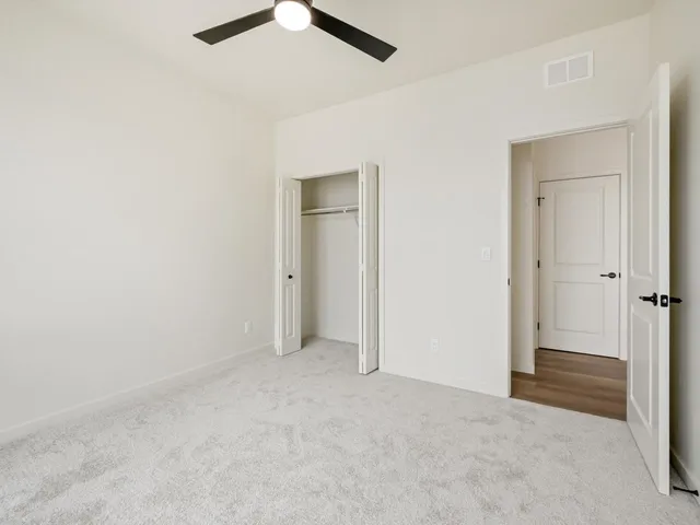 an empty room with closet area