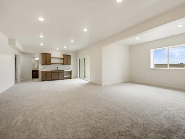 a view of a livingroom with furniture a ceiling fan and window