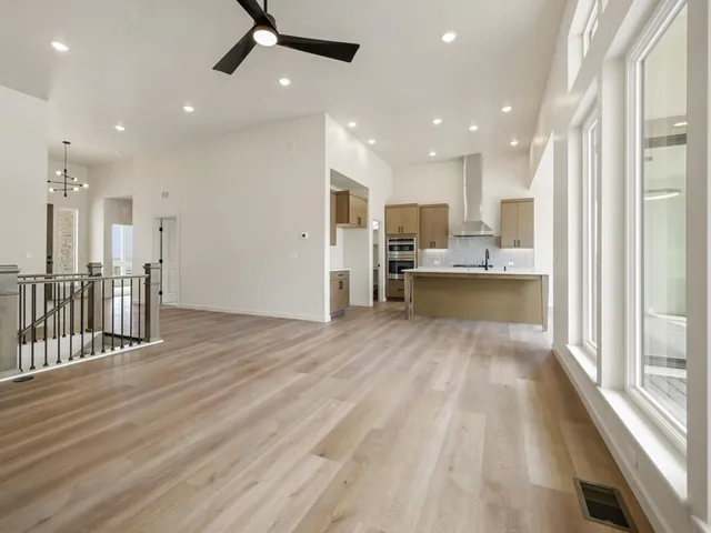 a view of a kitchen with wooden floor and a window