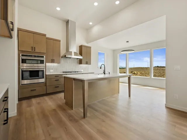 a kitchen with stainless steel appliances a stove sink and cabinets