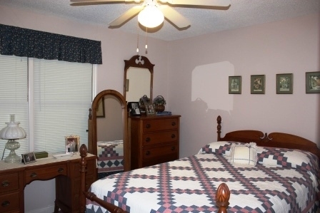 159 Floyd Road Forsyth, GA 31029 - Photo 14 of 31 a bedroom with a bed and a chandelier
