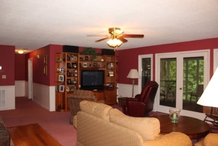 159 Floyd Road Forsyth, GA 31029 - Photo 3 of 31 a living room with furniture a flat screen tv and a fireplace