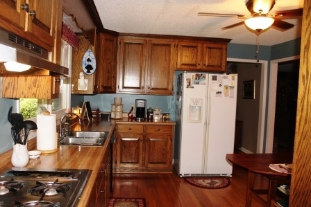 159 Floyd Road Forsyth, GA 31029 - Photo 7 of 31 a kitchen with stainless steel appliances granite countertop a refrigerator stove and sink