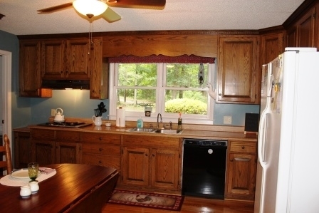 159 Floyd Road Forsyth, GA 31029 - Photo 8 of 31 a kitchen with stainless steel appliances granite countertop a sink a stove and a refrigerator