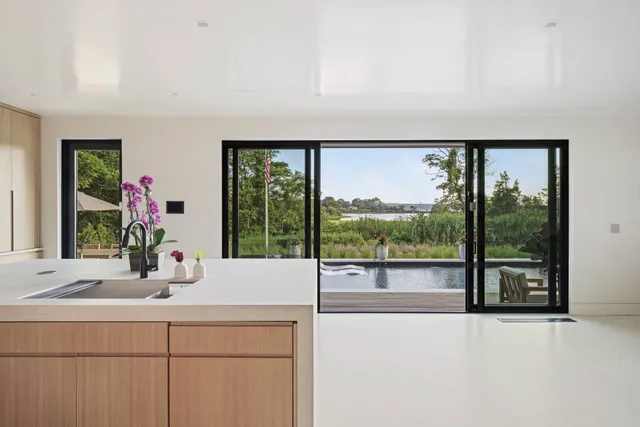 a living room with a large window and a fireplace