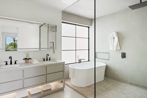 a bedroom with furniture and a large window