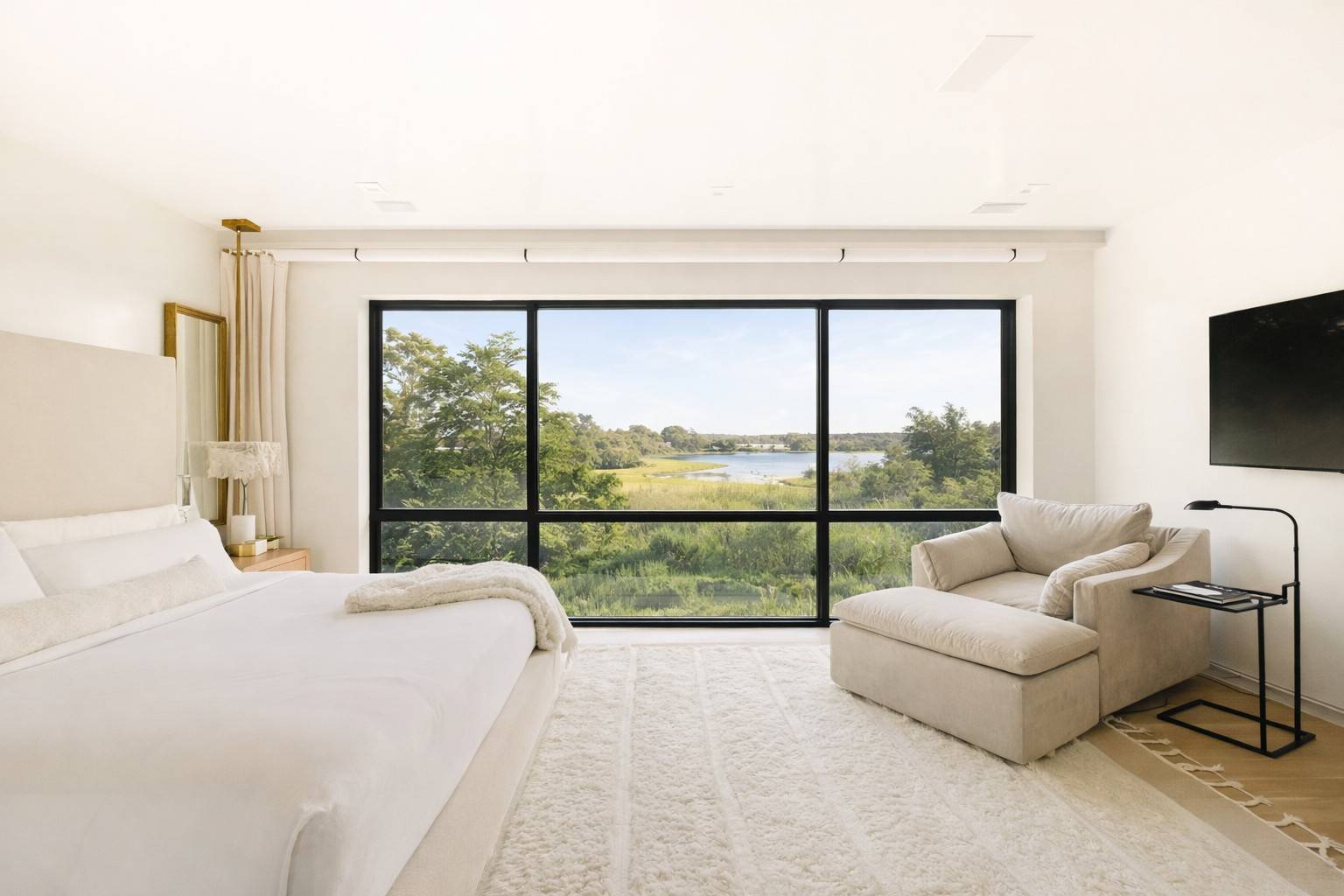 4 3rd Street Sag Harbor, NY 11963 - Photo 20 of 46 a bedroom with furniture and a large window