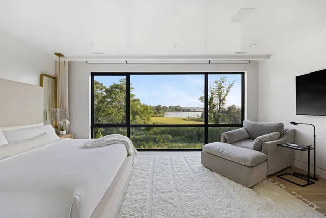 a bedroom with a large bed and a large window