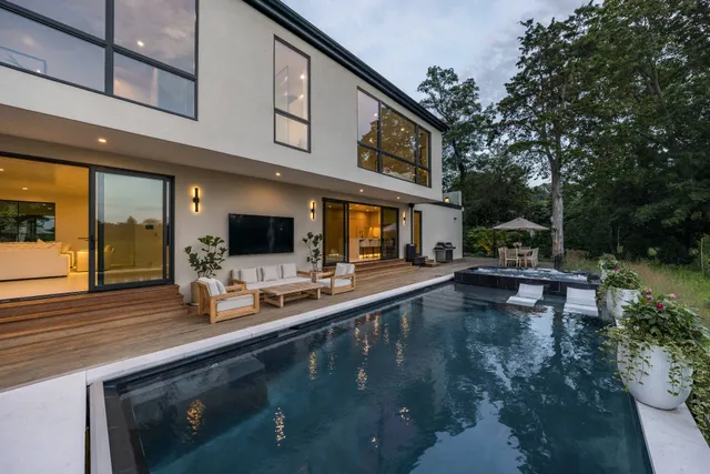 a view of a swimming pool with outdoor seating