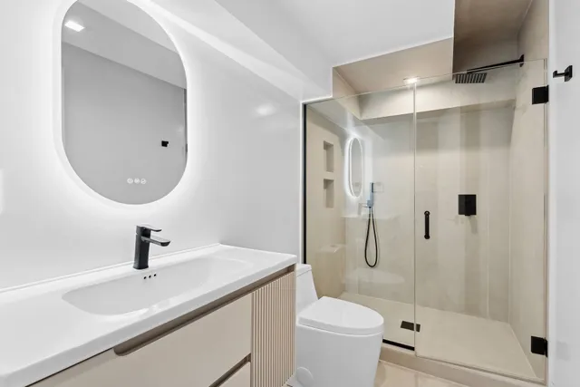 a bathroom with a sink toilet and shower