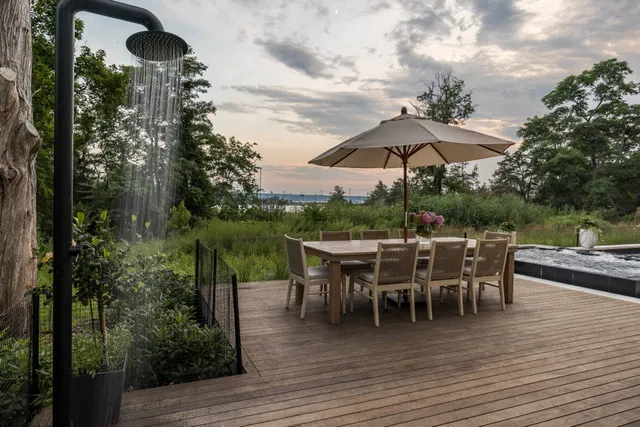 a view of a patio with table and chairs under an umbrella