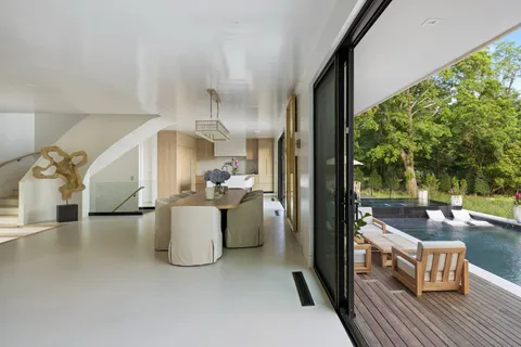 a view of a living room and kitchen with a large window