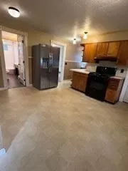 a kitchen with a sink and a refrigerator
