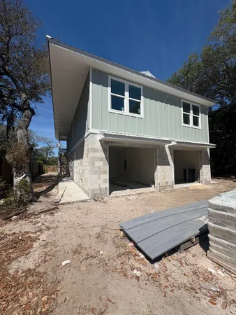 a view of a house with backyard and sitting area