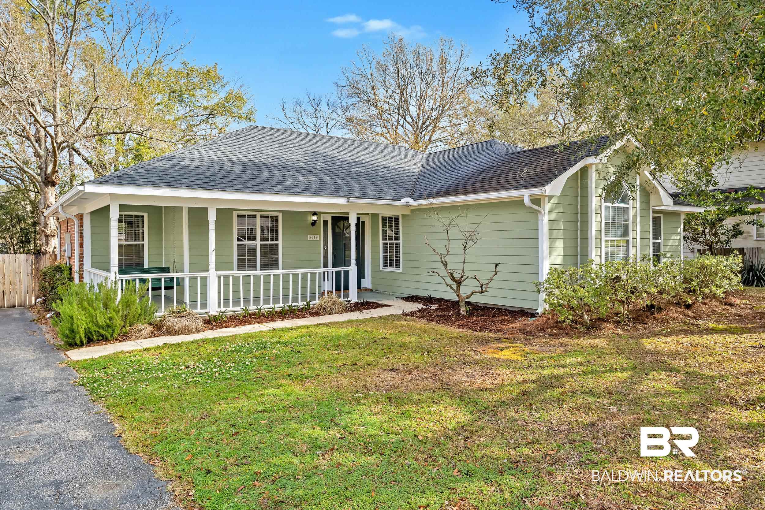 6616 Conde Court Mobile, AL 36695 - Photo 3 of 27 Ranch-style home with covered porch, a shingled roof, a front yard, and fence