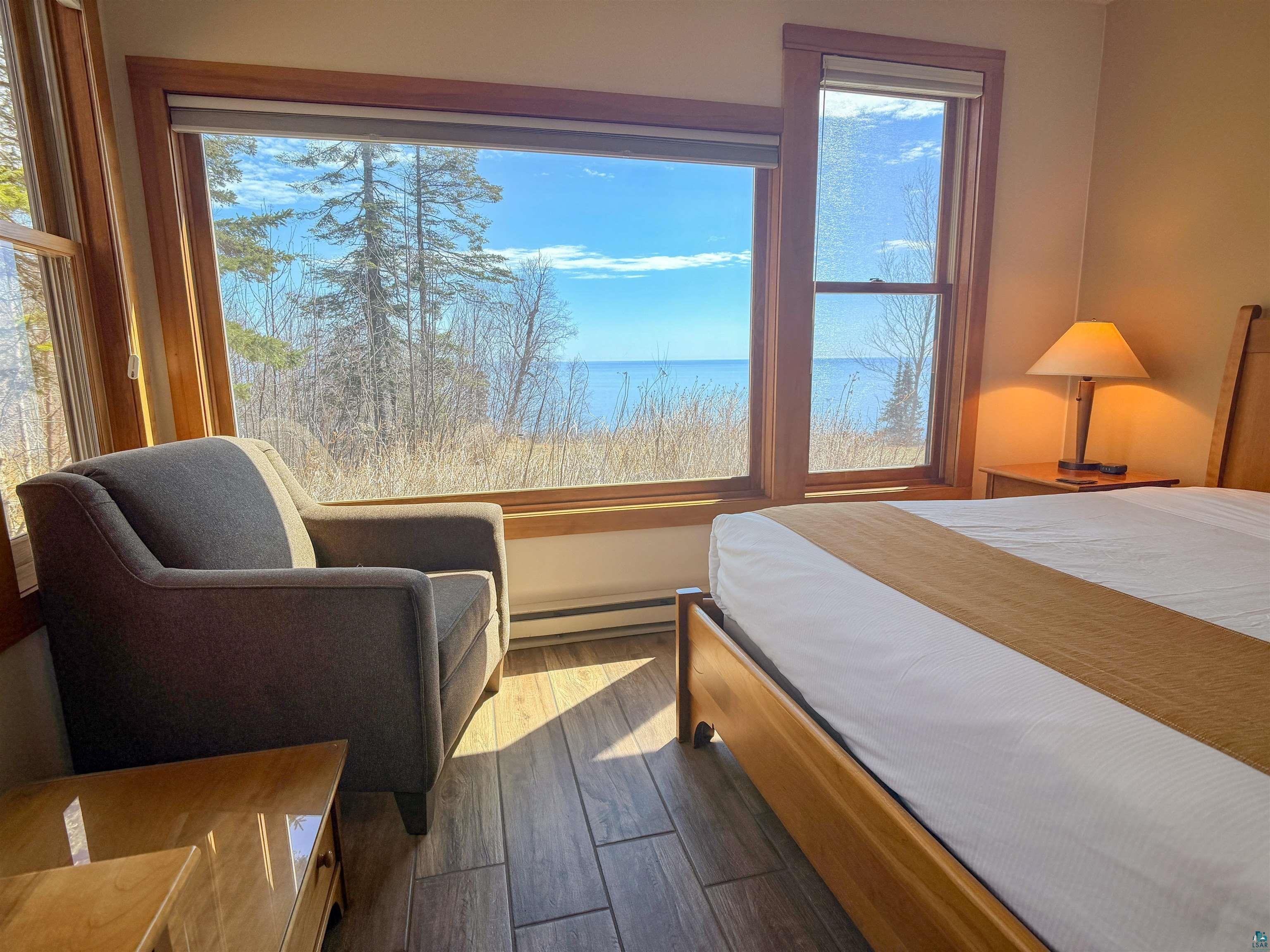 504-506 Poplar River Road, Unit 505 Lutsen, MN 55612 - Photo 32 of 39 Large picture window framing a prominent water body and natural outdoor scenery