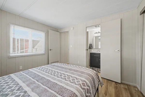 a bedroom with a bed and a window