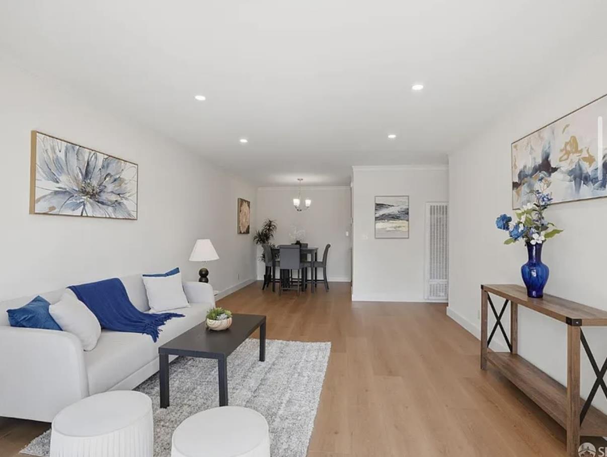 4081 Clayton Road, Unit 235 Concord, CA 94521 - Photo 6 of 19 a living room with furniture and a dining table with wooden floor