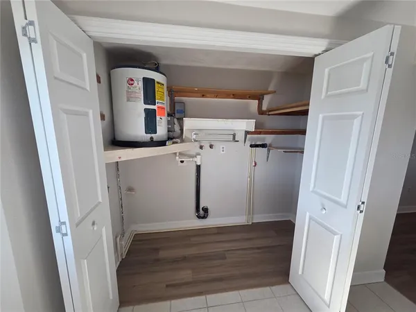 a view of storage and utility room with refrigerator