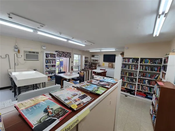 a living room with furniture and a bookshelf