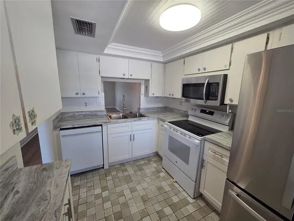 a kitchen with a sink appliances and cabinets
