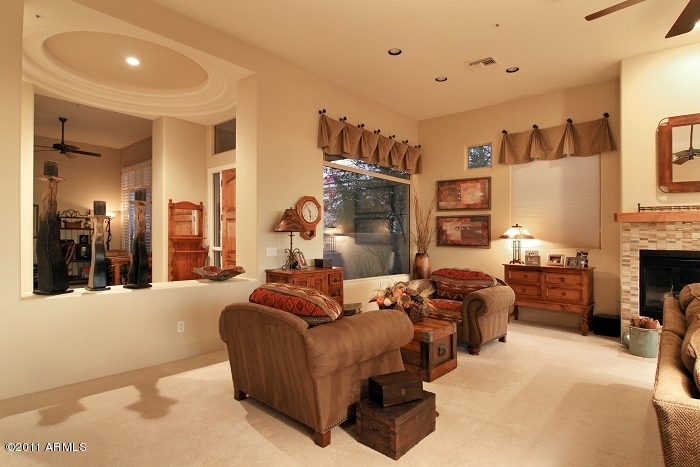 11059 East Turnberry Road Scottsdale, AZ 85255 - Photo 14 of 35 a large bedroom with furniture fireplace and a television
