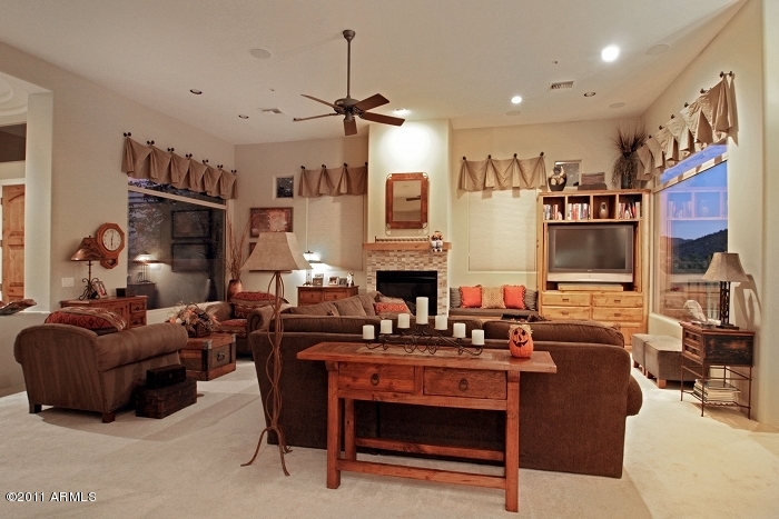 11059 East Turnberry Road Scottsdale, AZ 85255 - Photo 15 of 35 a living room with fireplace furniture and a flat screen tv