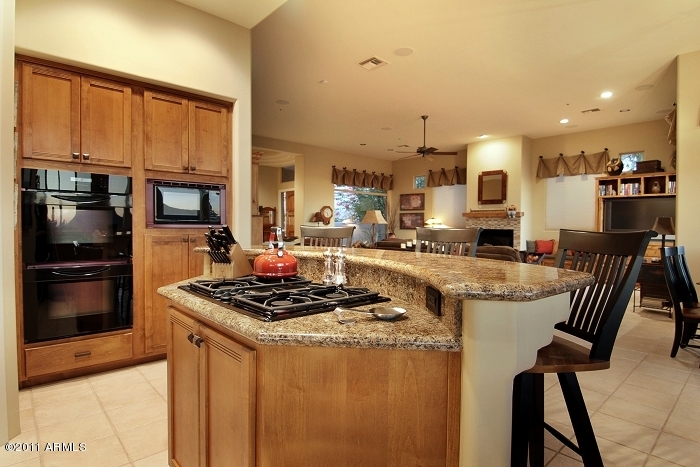 11059 East Turnberry Road Scottsdale, AZ 85255 - Photo 19 of 35 a kitchen with stainless steel appliances granite countertop a stove and a refrigerator