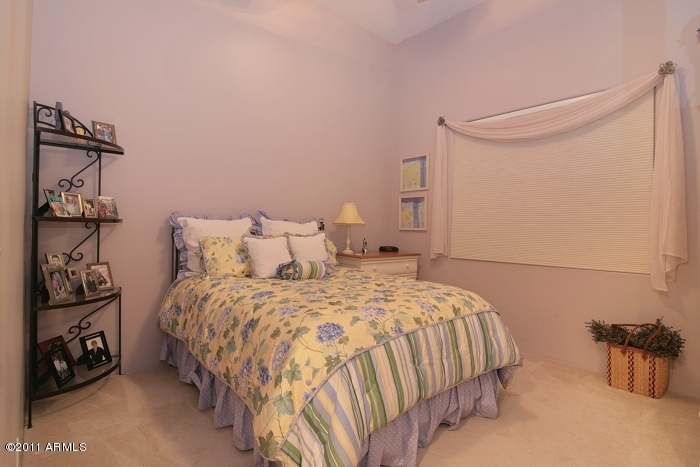 11059 East Turnberry Road Scottsdale, AZ 85255 - Photo 22 of 35 a bedroom with a bed and a wall painting