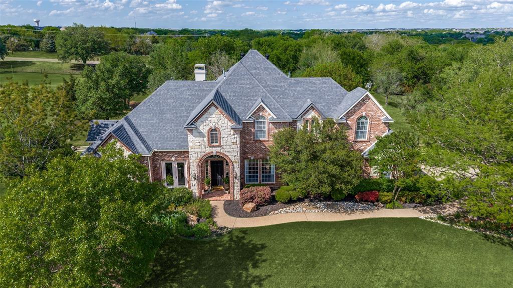 2841 Winding Creek Road Prosper, TX 75078 - Photo 3 of 40 a aerial view of a house with a yard table and chairs