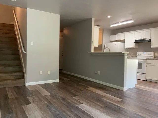 a view of kitchen and wooden floor