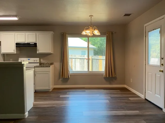 a view of a kitchen with dishwasher and wooden floor