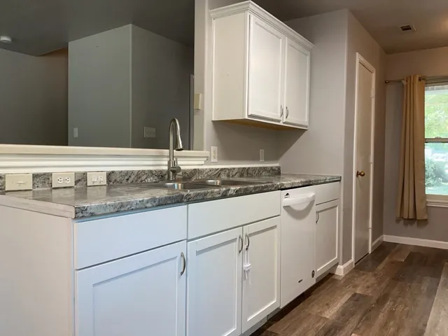 a sink with granite countertop cabinets and a sink