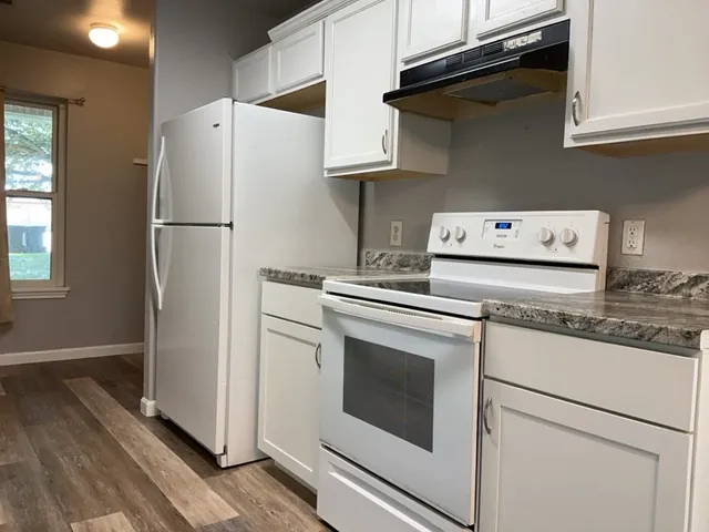 a white refrigerator freezer sitting inside of a kitchen