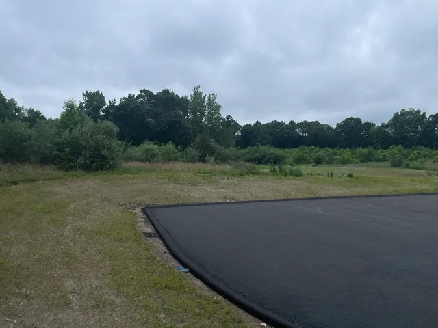 a view of a lake with houses in the back