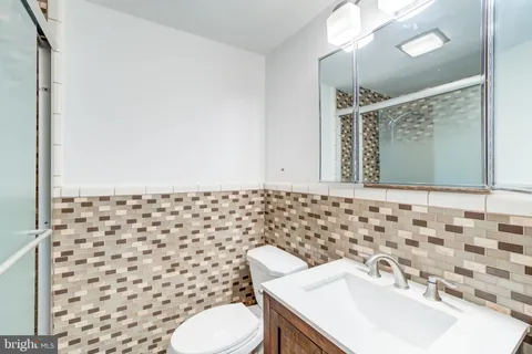 a bathroom with a black and white shower curtain