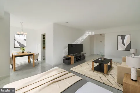 a living room with furniture a large window and a potted plant