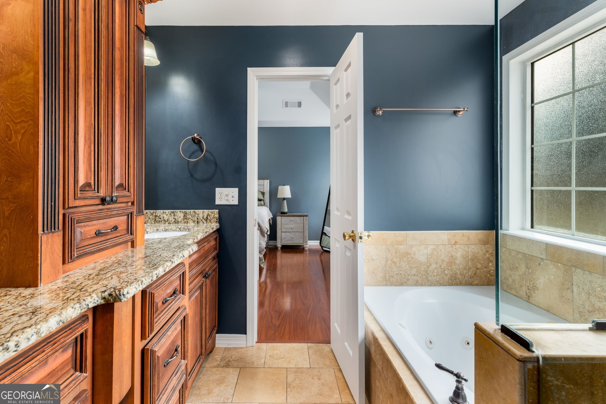 113 Hummingbird Lane Kathleen, GA 31047 - Photo 15 of 44 a en suite bathroom with a granite countertop sink and a tub