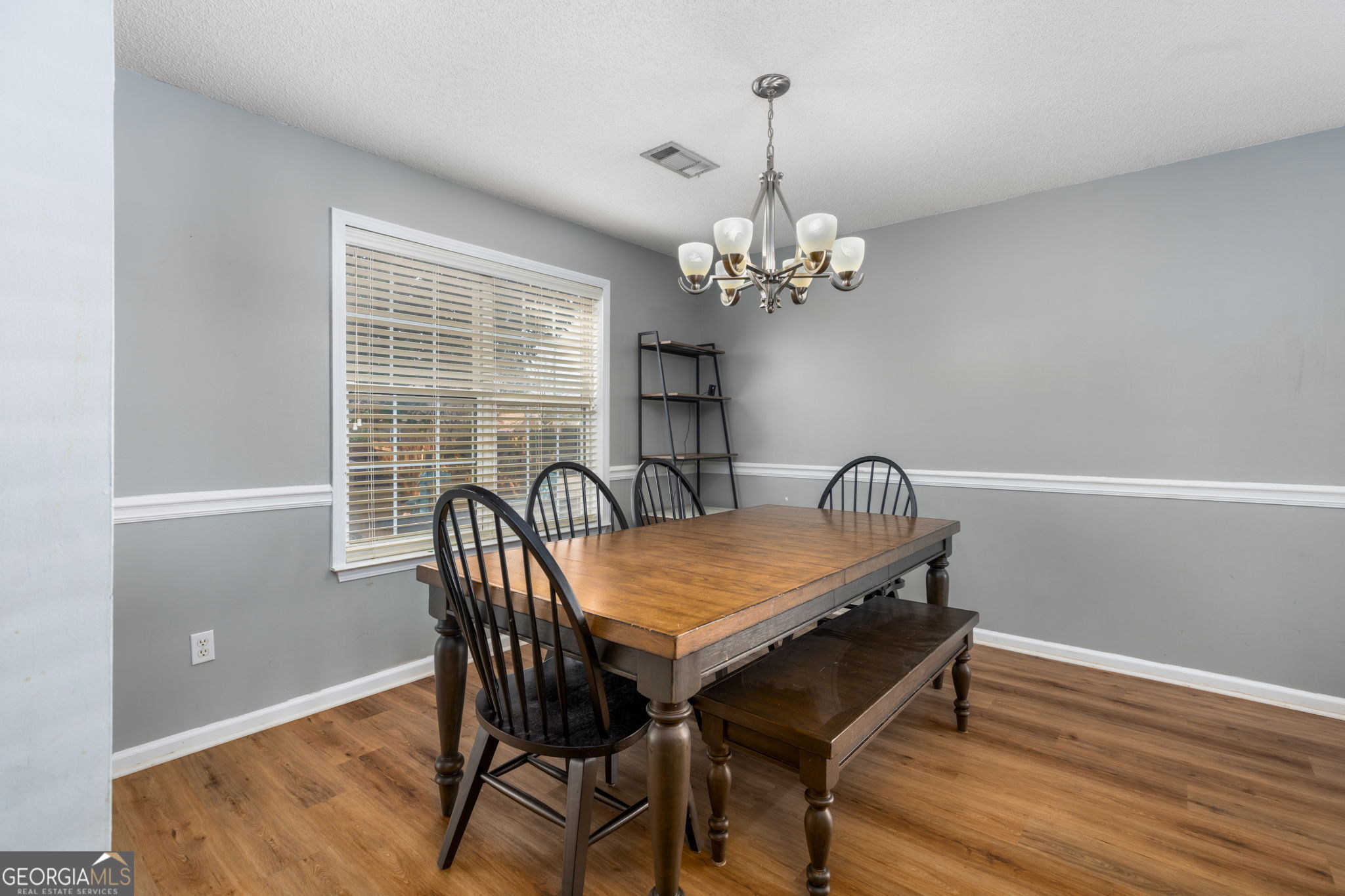 113 Hummingbird Lane Kathleen, GA 31047 - Photo 25 of 44 a view of a dining room with furniture a chandelier and wooden floor