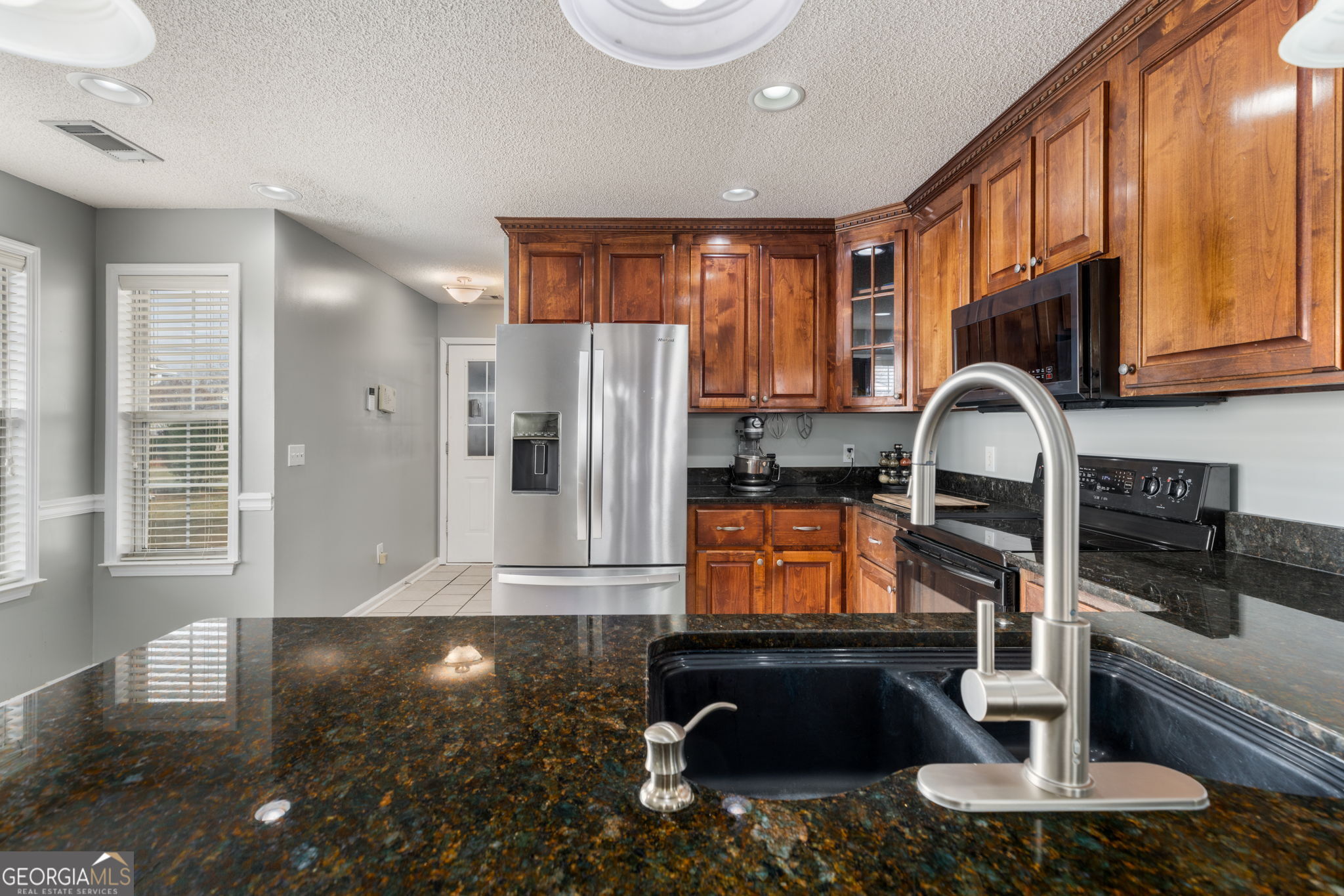 113 Hummingbird Lane Kathleen, GA 31047 - Photo 26 of 44 a kitchen with a refrigerator and a sink