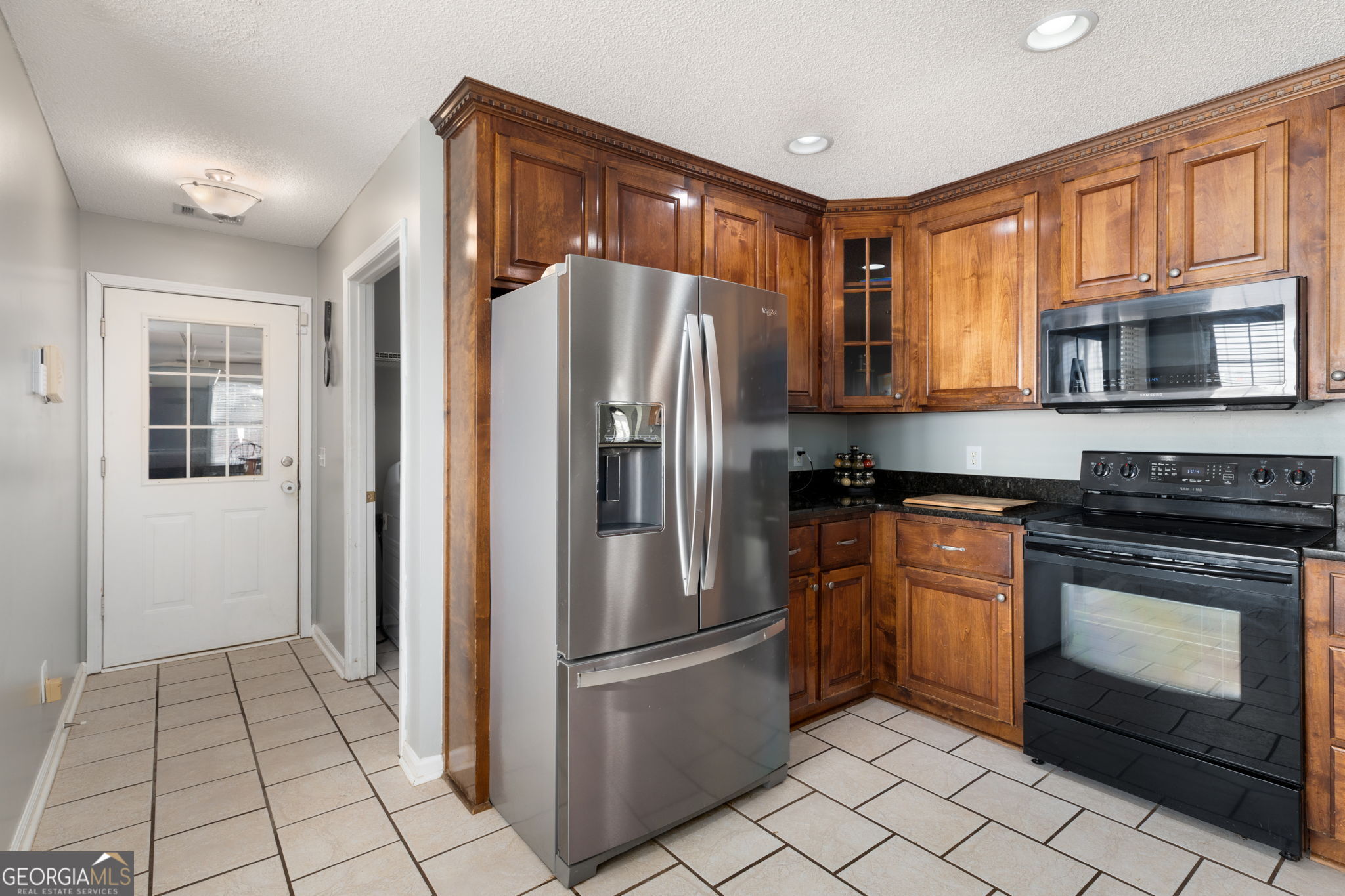 113 Hummingbird Lane Kathleen, GA 31047 - Photo 28 of 44 a kitchen with granite countertop a refrigerator stove top oven and sink