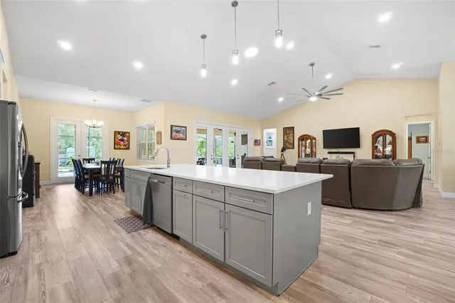 a kitchen with stainless steel appliances white cabinets and wooden floors
