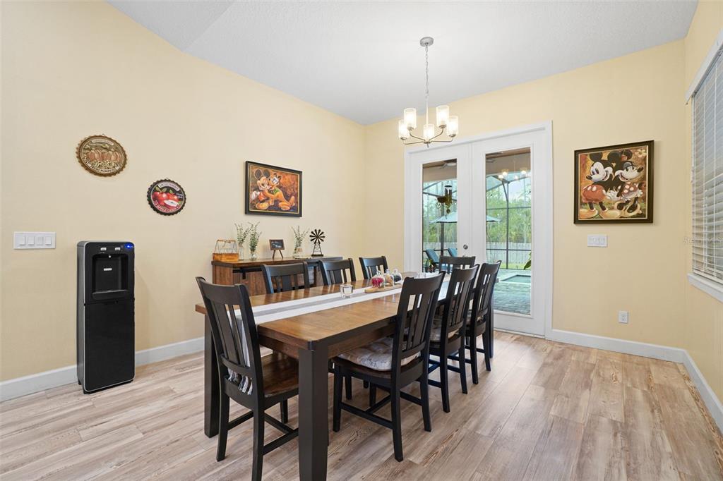 3230 Pheasant Trail Mims, FL 32754 - Photo 16 of 71 a view of a dining room with furniture and wooden floor